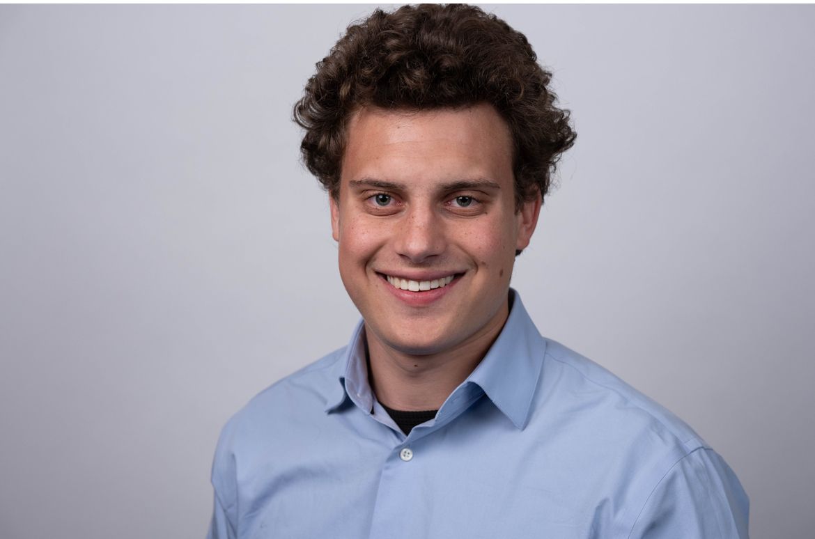 Campaign headshot of Jake Horvitz in a light blue shirt against a grey backdrop.